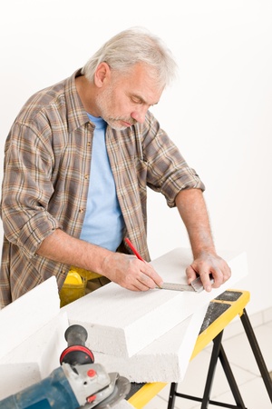 Home improvement - handyman measure porous brick in workshopの写真素材