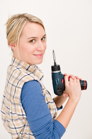 Home improvement - woman with battery cordless screwdriverの写真素材