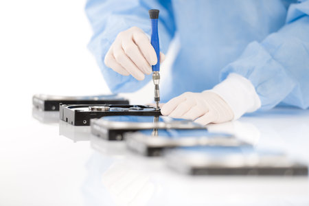 Computer engineer repair hard disc defect, experiment in sterile laboratoryの写真素材