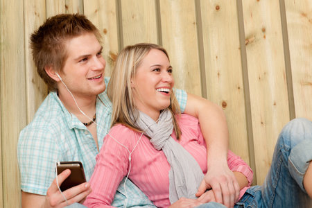 Couple in love - summer fun on beach listen to musicの写真素材