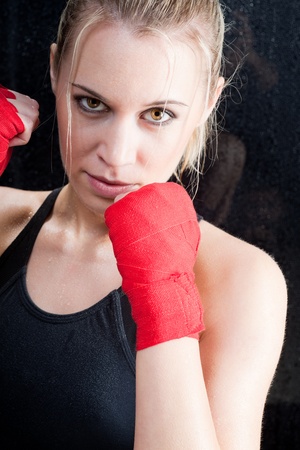 Boxing training blond woman sparring and sweatingの写真素材