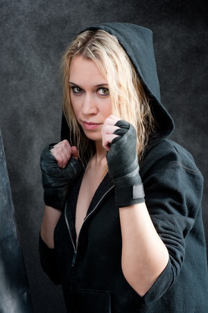 Tough boxing training woman in black grunge backgroundの写真素材