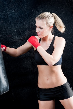 Boxing training blond woman sparring and sweatingの写真素材