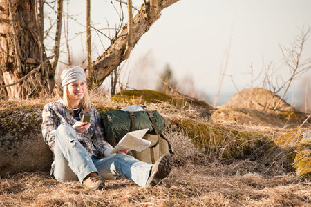 Camping young woman search navigation compass map in countrysideの写真素材
