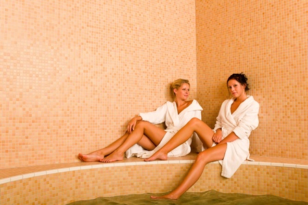 Relax bath spa two beautiful women bathrobe sittingの写真素材