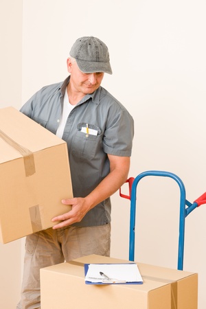 Messenger mature male courier delivering parcel boxes. Shipping and logistics.の写真素材