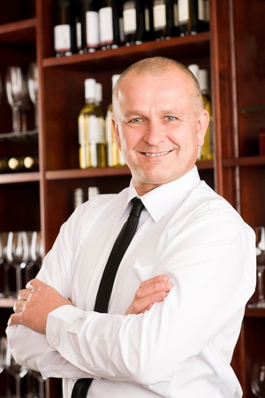 Wine bar waiter male in restaurant posing with cross armsの写真素材