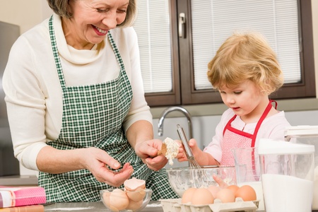 Grandmother and granddaughter baking cookies prepare doughの写真素材