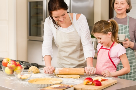 Mother and daughter making apple pie together grandmother check recipeの写真素材