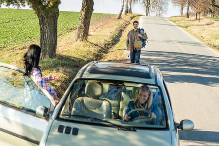 Young man road trip girl friends offer lift with car