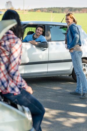 Car troubles two woman friends asking help young man