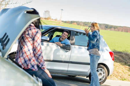 Car troubles two woman friends asking help young man