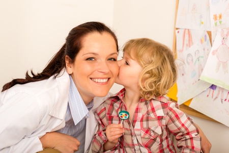 Thank you doctor - Little girl kissing female pediatricianの写真素材