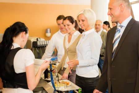 Cafeteria cashier woman check guest list businesswoman take buffet lunchの写真素材