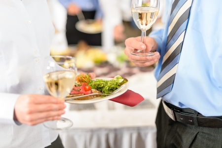 Refreshments at business meeting close-up appetizer plate and wineの写真素材