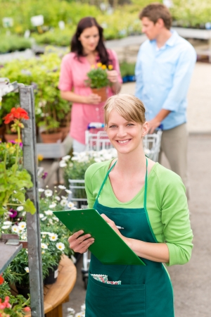 Female florist working at garden center do retail inventoryの写真素材