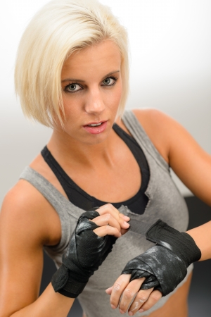 Kick-box woman wear protective gloves prepare for fitness workoutの写真素材