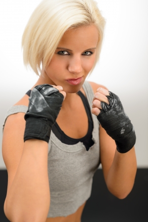 Rough woman ready to fight with boxing bandage glovesの写真素材