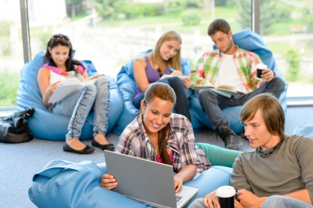 Students sitting on beanbags study room high-school teens happyの写真素材