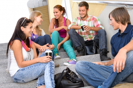 Students laughing on school stairs in break teens college relaxing Students laughing on school stairs in break teens college relaxing
