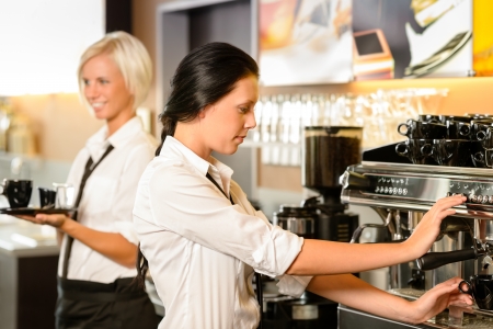 Staff at cafe making coffee espresso machine woman working barの写真素材
