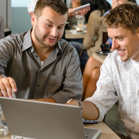 Men business partners working on laptop cafe restaurantの写真素材