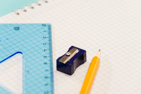 Sharpener with ruler, pencil on notepad school supplies