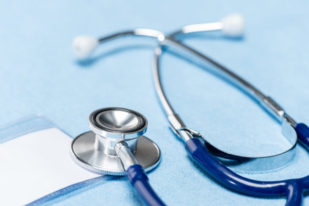 Blue stethoscope over doctor coat medical equipment close-up
