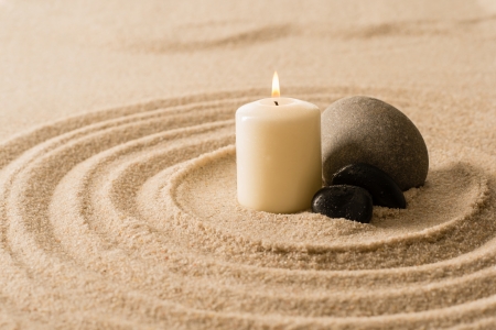 Spa atmosphere candle with zen stones in sand still natureの写真素材