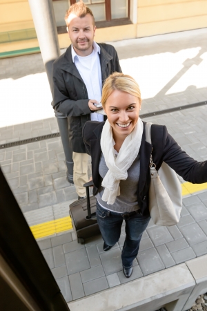Woman getting on the train man smiling friends commuting journeyの写真素材