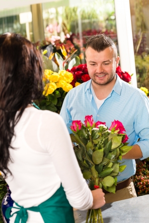 Husband buying roses bouquet romantic flower market floristの写真素材