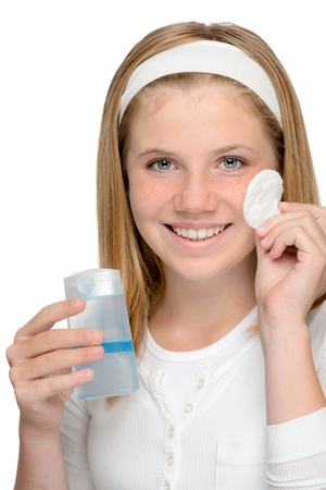 Cheerful smiling girl removing cleaning make-up face lotionの写真素材