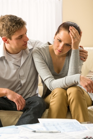 Young worried couple has problems with their budgetの写真素材