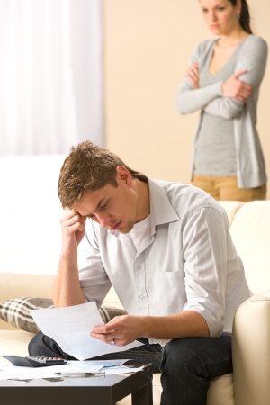 Stressed man and woman arguing about family budgetの写真素材