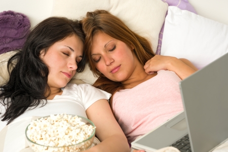 Best friends fell asleep during watching a movieの写真素材