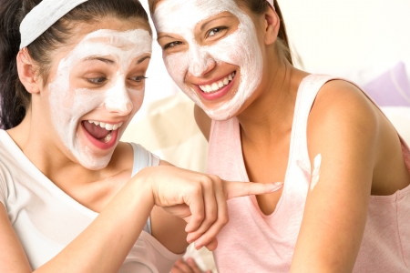 Laughing caucasian girls wearing peeling mask having funの写真素材