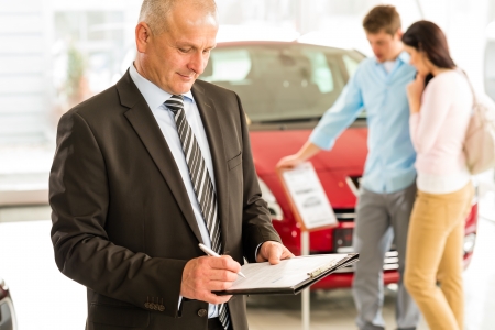 Portrait of Caucasian salesman in car showroomの写真素材