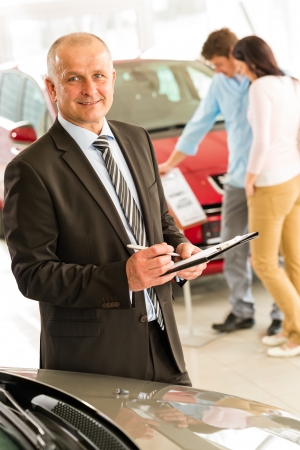 Closeup portrait of salesman working in car dealershipの写真素材