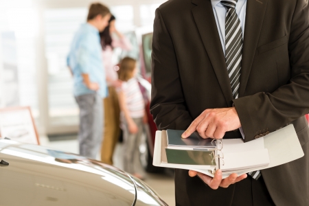 Closeup of car salesman's hands holding color swatchesの写真素材