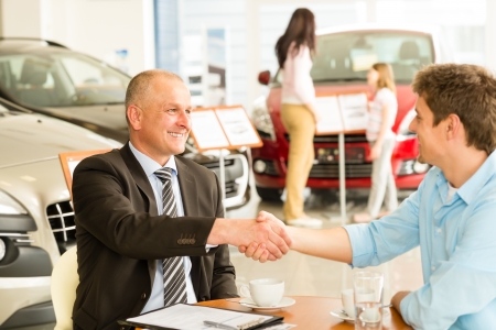 Caucasian customer and car salesman shaking handsの写真素材