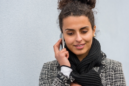 Smiling woman talking on the mobile phoneの写真素材