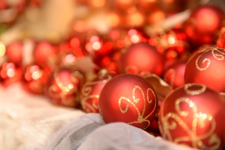 Pile of red Christmas balls with gold ornamentの写真素材