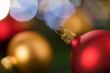 Christmas red and gold balls close-up shining lights backgroundの写真素材