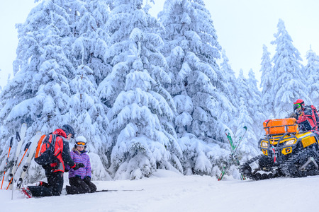 Ski patrol helping woman with broken arm rescue quadの写真素材