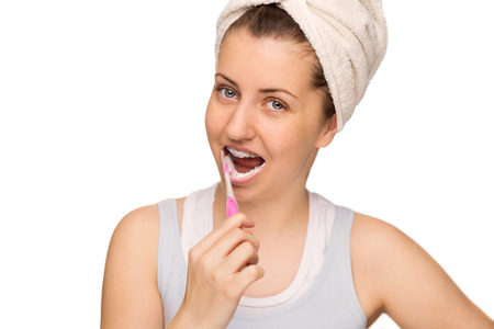Teenage girl with braces brushing teeth morning hygiene isolatedの写真素材