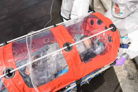 Biohazard medical team with sick patient in stretcher virus contamination