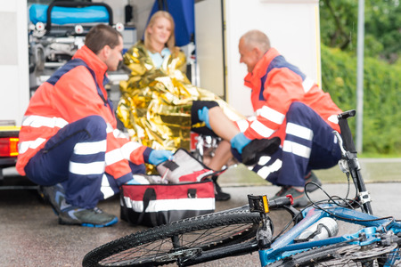Accident bike woman get emergency help paramedics in ambulanceの写真素材