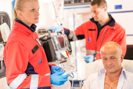 Paramedics in ambulance with patient heart attack treatment emergency sickの写真素材