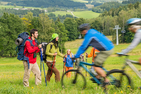 People hiking and riding bikes on summer vacation nature landscapeの写真素材