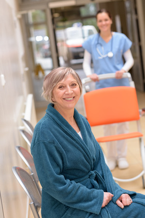 Senior patient sitting in hospital waiting for nurse with wheelchairの写真素材